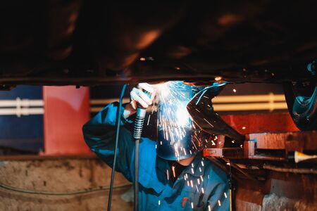 Man in a mask does welding machines.の写真素材