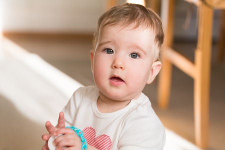 Beautiful little child. Close up portrait in home.の写真素材