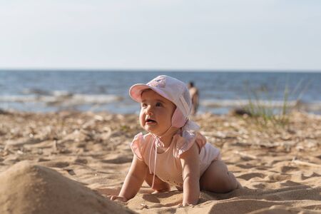 little child is playing on the beachの写真素材