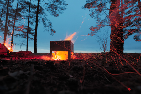 Burning firewood in the barbecue against the sky.の写真素材