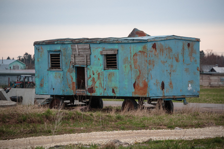 blue and rusty cabins in the fieldの写真素材