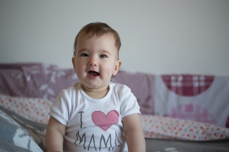 happy and joyful little baby on the couch