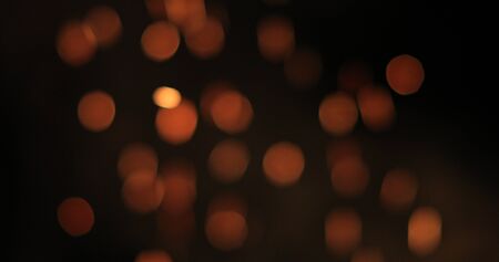 bright and fiery bokeh on a black backgroundの写真素材