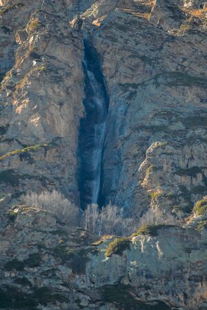 waterfall in a mountainous area in the daytimeの写真素材