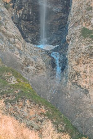 waterfall in a mountainous area in the daytimeの写真素材