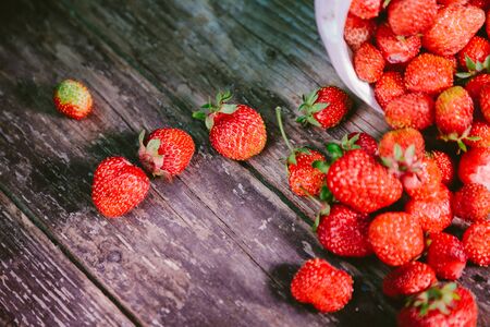 sprinkled natural and fresh strawberry from a white bucketの写真素材