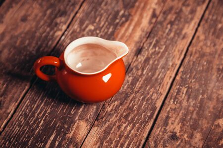 red Chinese gaiwan on an old wooden tableの写真素材
