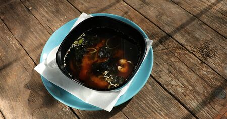 japanese miso soup with shrimps on an old wooden tableの写真素材