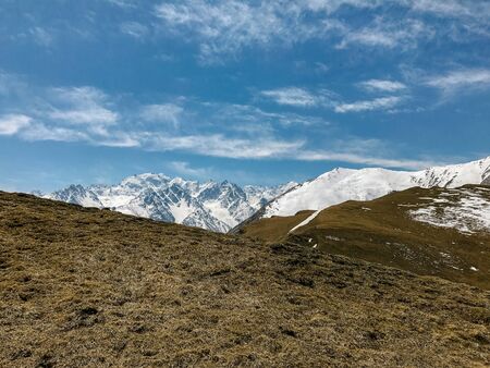 landscape of mountains and hills covered with snow against the sky