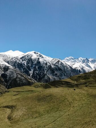 landscape of mountains and hills covered with snow against the sky