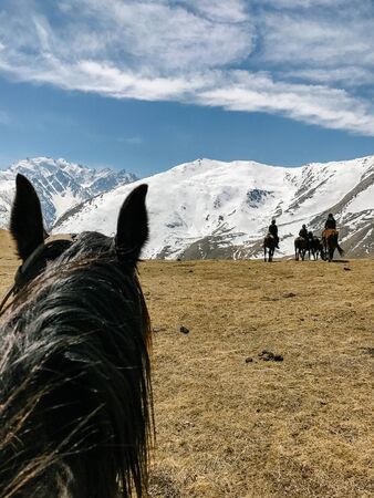 riding a horse first person view of the mountain and skyの写真素材