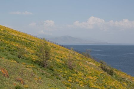 picturesque hill on the background of the sea and mountains