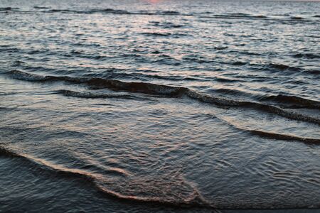 photo of the tide of water on a sandy beachの写真素材