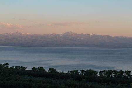 evening landscape of the sea against the backdrop of mountains and clouds