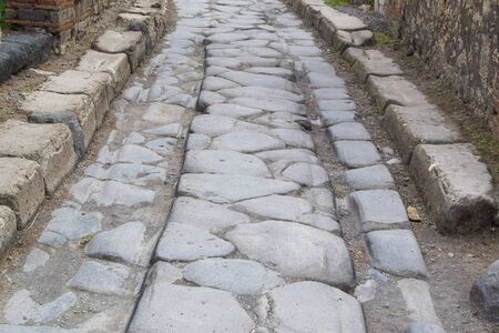 old hiking trail paved with stones in the daytimeの写真素材