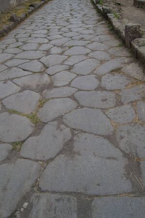 old hiking trail paved with stones in the daytimeの写真素材