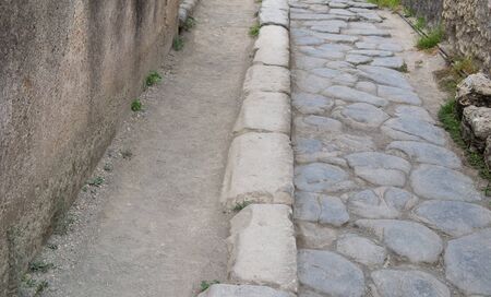 old hiking trail paved with stones in the daytimeの写真素材
