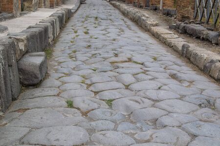old hiking trail paved with stones in the daytimeの写真素材