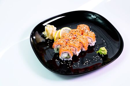 photo of Japanese rolls in a black plateの写真素材