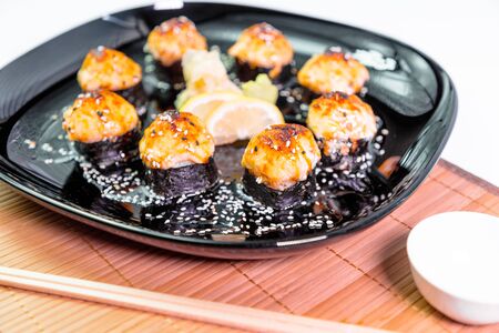 photo of baked Japanese rolls in a black plateの写真素材
