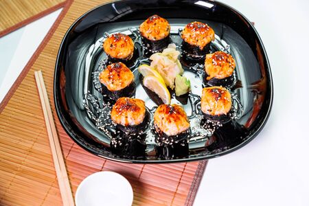 photo of baked Japanese rolls in a black plateの写真素材
