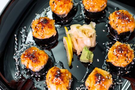 photo of baked Japanese rolls in a black plateの写真素材