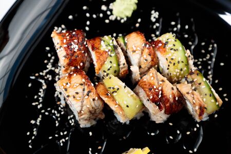 photo of Japanese rolls in a black plateの写真素材