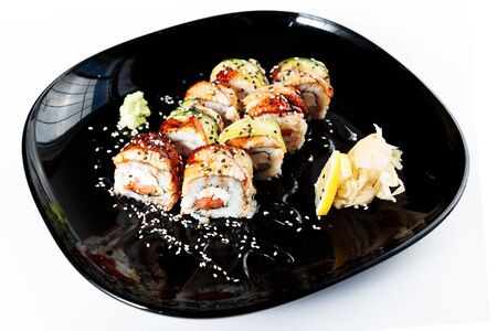 photo of Japanese rolls in a black plateの写真素材