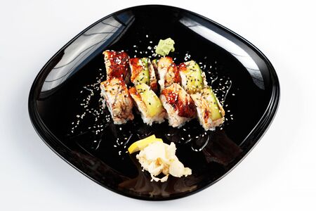 photo of Japanese rolls in a black plateの写真素材