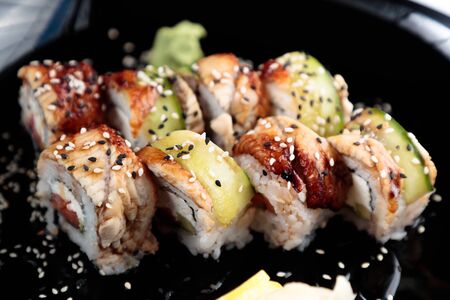 photo of Japanese rolls in a black plateの写真素材