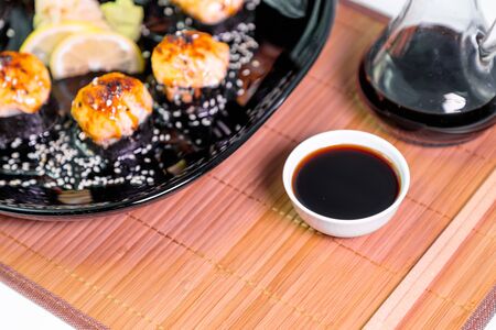 photo of baked Japanese rolls in a black plateの写真素材