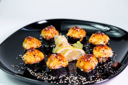 photo of baked Japanese rolls in a black plateの写真素材
