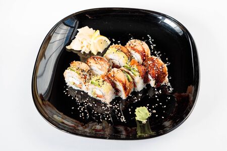 photo of Japanese rolls in a black plateの写真素材