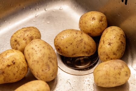 potatoes in the sinkの写真素材