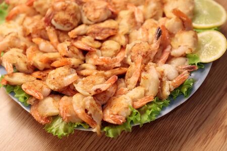 Fried Shrimp in batter on plates with lemon close-upの写真素材