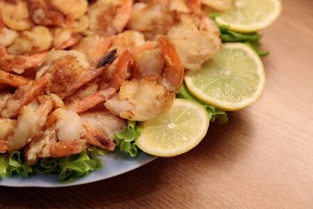 Fried Shrimp in batter on plates with lemon close-upの写真素材