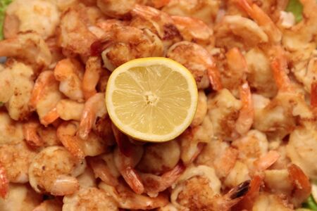 Fried Shrimp in batter on plates with lemon close-upの写真素材