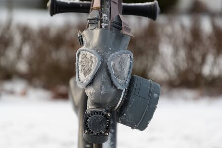 old rubber gas mask on the street in winterの写真素材