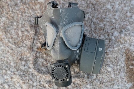 old rubber gas mask on the street in winterの写真素材