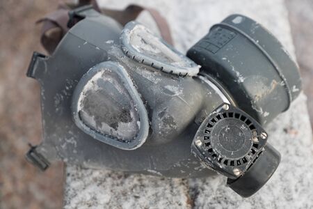 old rubber gas mask on the street in winterの写真素材