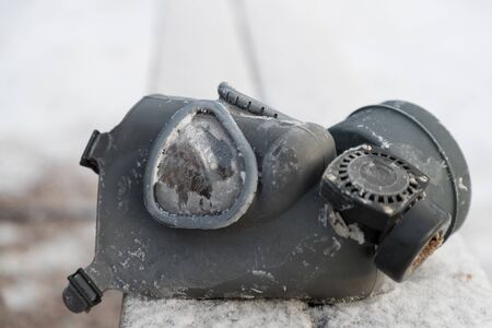 old rubber gas mask on the street in winterの写真素材