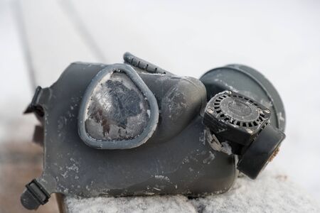 old rubber gas mask on the street in winterの写真素材