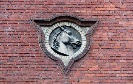 bas-relief of a horses head on a brick wallの写真素材