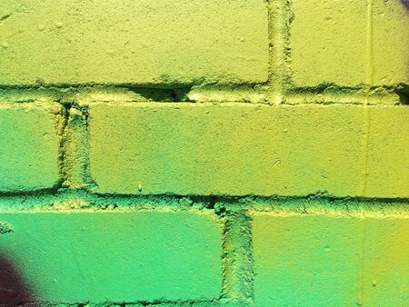 colorful paint on an old brick wall close upの写真素材