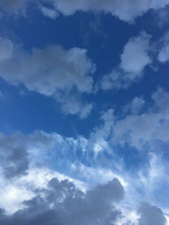 bright blue sky with white clouds at daytimeの写真素材