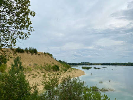 Old abandoned sand pit on a summer cloudy dayの写真素材