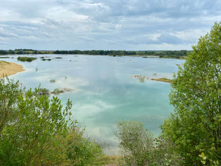 Old abandoned sand pit on a summer cloudy dayの写真素材