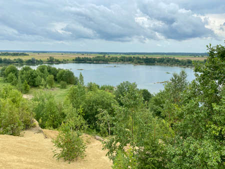 Old abandoned sand pit on a summer cloudy dayの写真素材