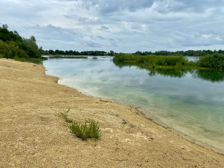 Old abandoned sand pit on a summer cloudy dayの写真素材