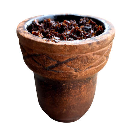 clay bowl with tobacco for smoking hookah side view on a white isolated backgroundの写真素材